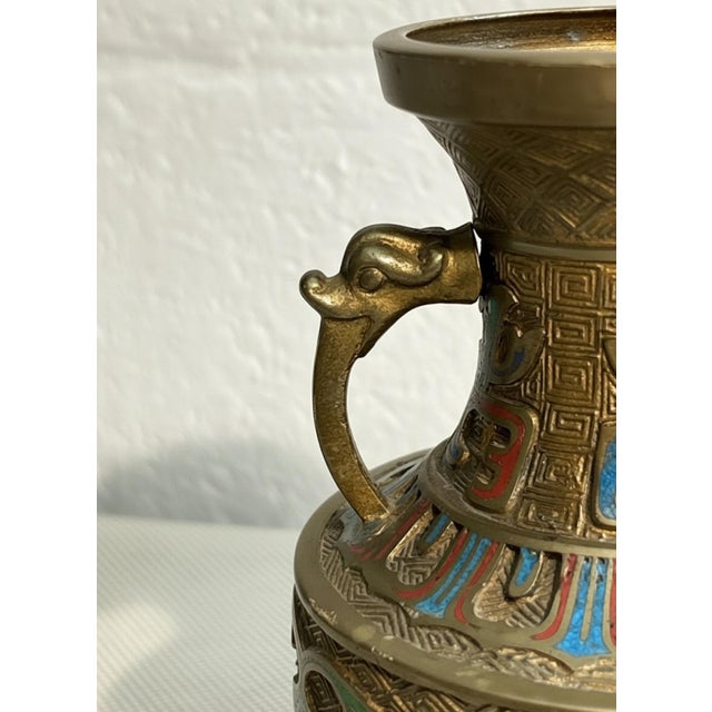 A richly decorated vintage Asian champlevé enamel vase featuring an archaistic form, intricate geometric texturing and a...