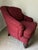 Very comfortable chair and ottoman pair in wine red fabric with subtle diagonal pattern. Wooden feet with decorative base....