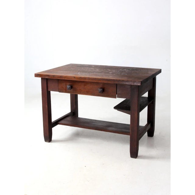 This antique Mission oak desk exemplifies the timeless elegance of the Arts and Crafts movement, featuring clean, simple...