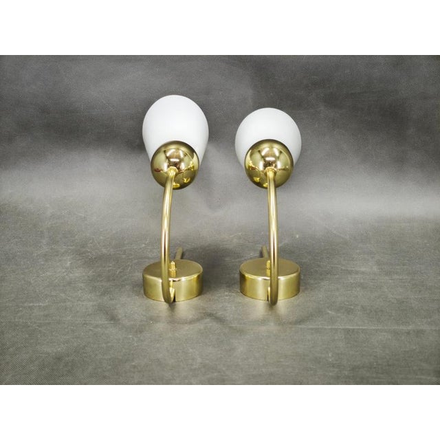 An elegant pair of wall lights produced by kamenický šenov, czechoslovakia, during the 1970s. Their refined composition...