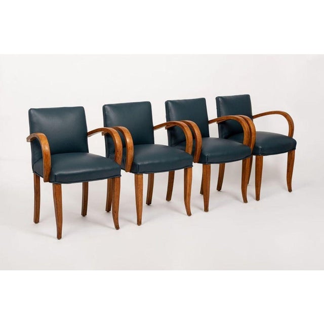 This exceptional set of four antique Art Deco leather upholstered dining chairs circa 1930 feature an elegant and unique...