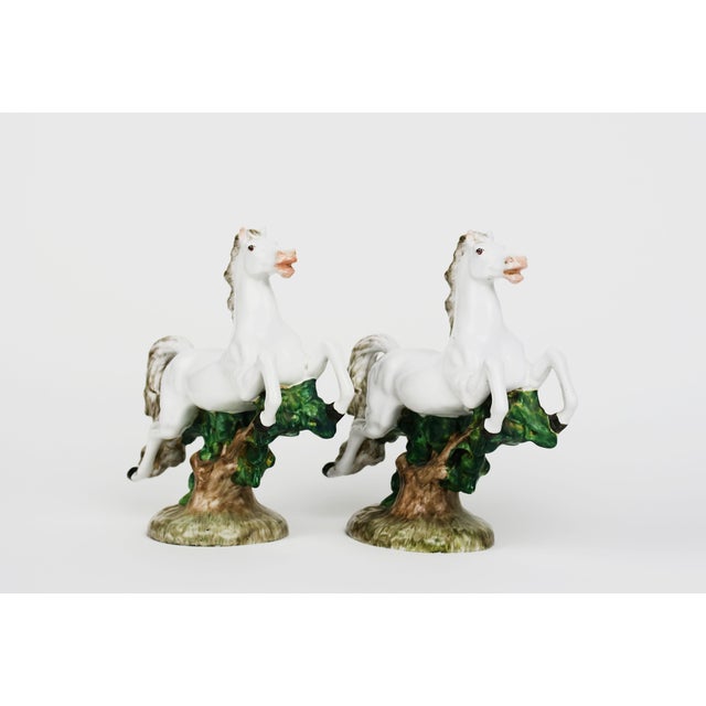 20th Century Pair of Italian Porcelain Figure Of Horses The figurines depict rearing horses, a classic equestrian pose...