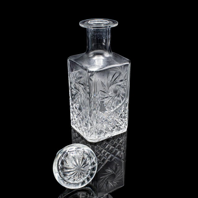 This is a vintage whiskey decanter. An English, cut glass brandy or spirit vessel, dating to the late 20th century, circa...