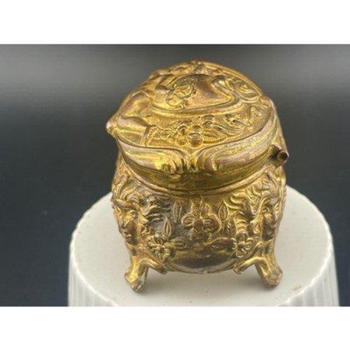 Antique cast brass jewelry casket featuring a high-relief reclining cherub (putto) surrounded by flowing Art Nouveau...