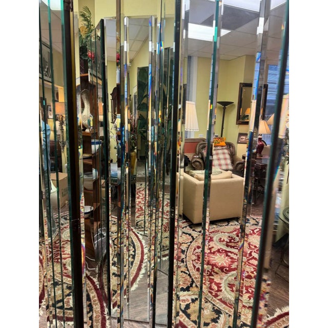 A striking vintage mirrored folding screen by Henredon, offering high-impact glamour and architectural presence. Composed...