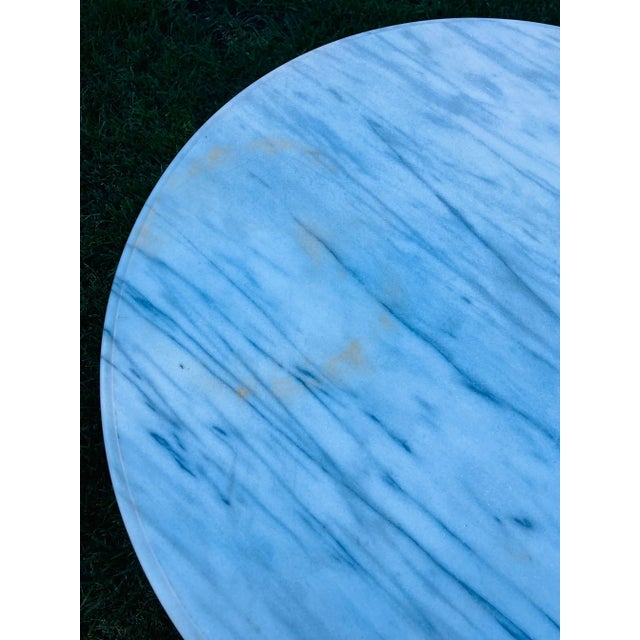 This iron table has a marble top. All three iron legs have a maidens face. The marble top is removable and can be attached.