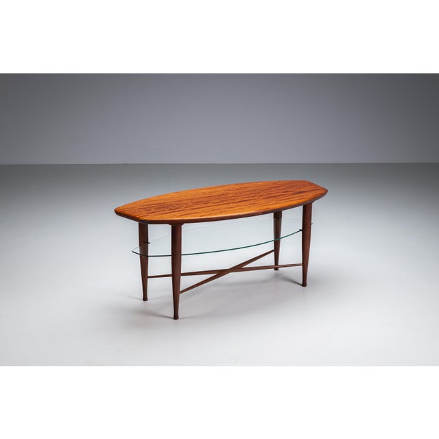 This asymmetrical coffee table balances sculptural form with refined craftsmanship. Its organically shaped wooden top...