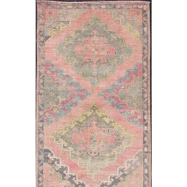 Colorful Vintage Hand Knotted Turkish Oushak Runner in muted tones Measures: 3'4 x 12'3. This vintage Turkish Oushak...