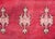 A stunning early 20th century Moroccan Berber runner with a large central diamond medallion amidst a rich crimson field of...