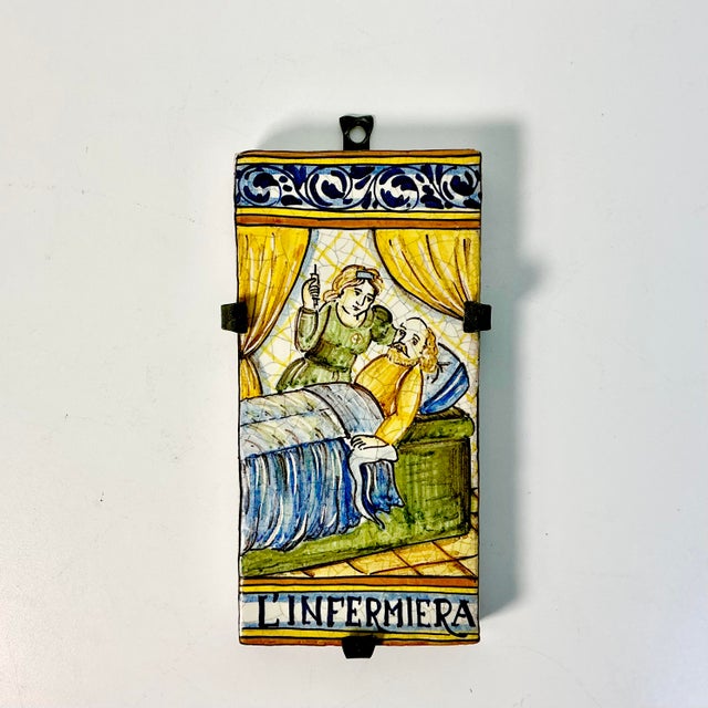 Vintage Home is pleased to offer this vintage hand-painted Italian Castelli decorative tile with an iron bracket to...