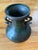 This vintage 11-inch Asian bronze amphora vessel features stylized dragon-form handles and a rich, mottled verdigris and...