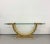 A dramatic vintage console table featuring a sculptural U-shaped base finished in a glossy lacquered faux-stone pattern....