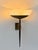 Large wall light produced in France in the 1930s, featuring a patinated brass arm and a acrylic glass diffuser. Timeless,...