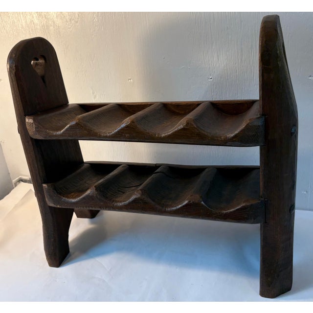 Love this heavy wood castle wine rack with carved heart cut outs.