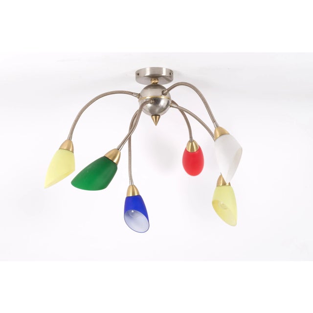 A set composed of two appliques and one wall lamp in metal and colored glass, Italian Manufacture, 1960s. Measurements: 18...
