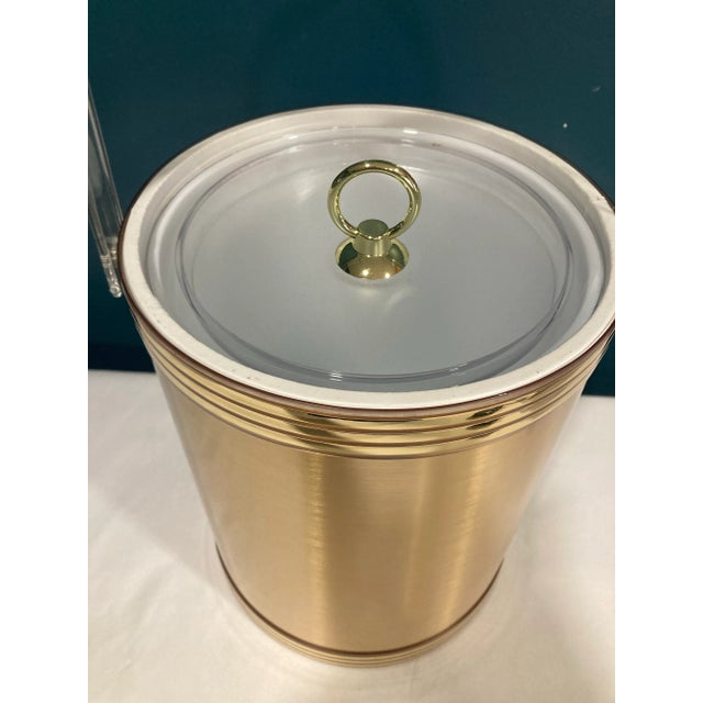 This lovely vintage ice bucket by Custom Deco features a sleek gold rim and a clear acrylic lid topped with a coordinating...