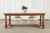 Impressive country French provincial farmhouse dining table crafted from thick planks of fruitwood. The table features a...