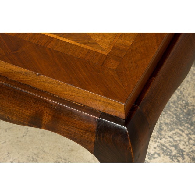 Elegant 1940s French Art Deco coffee table sourced in Paris, France. Crafted in walnut, the table features a rectangular...