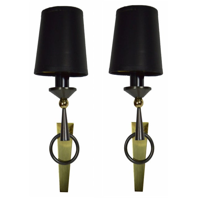 A pair of patina brass French pair of sconces from 1960 designed by Jacques Adnet. This features gold and gunmetal. US...