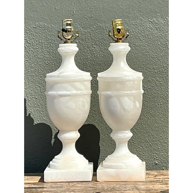 This exquisite pair of vintage table lamps is masterfully carved from solid Italian alabaster, showcasing a timeless...