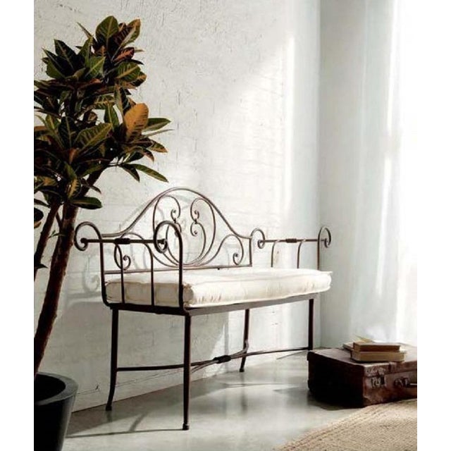 About A wonderful French wrought iron Baguès style bench with lattice seat and scrolled arms. Cushion included. Additional...