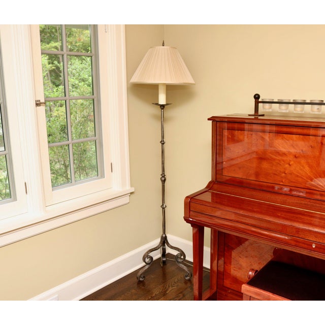 Vintage wrought iron candlestick floor lamp with a double scrolled tripod base and a beautifully pleated shade. Product...