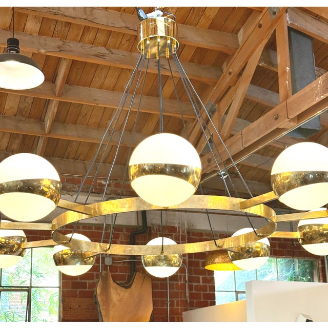 This elegant Stilnovo chandelier is a refined example of Italian mid-century modern lighting design, combining sculptural...