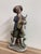 Capodimonte porcelain statue depicting an elderly hunter with his dog, height 26 cm, width 11 cm, depth 9 cm