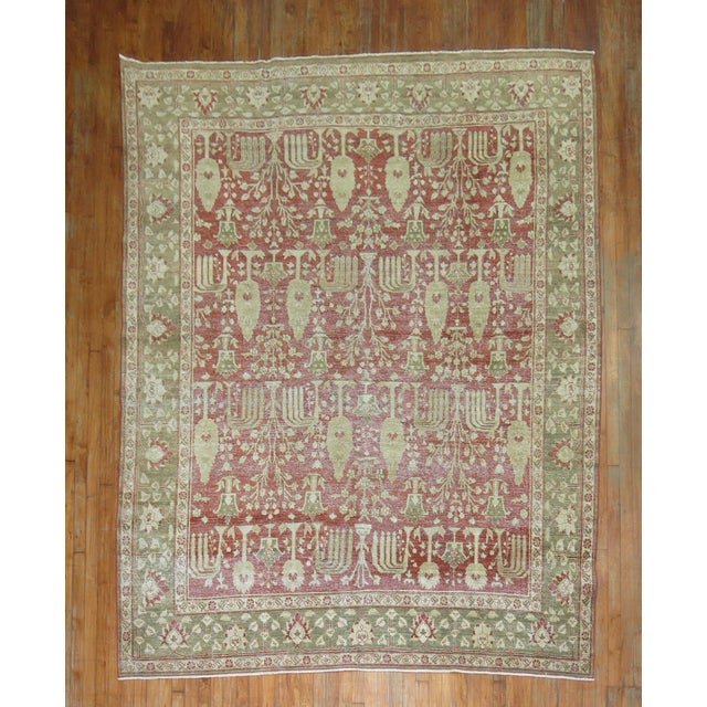 Beautifully naturally Worn early 20th-century Persian Tabriz rug in reds, greens, and browns. An all-over willow tree...