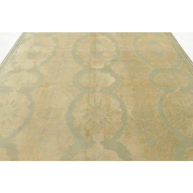 Hand-knotted in wool circa 1900-1920, this antique 9x10 Hereke rug from Turkey features an elegant all-over medallion...