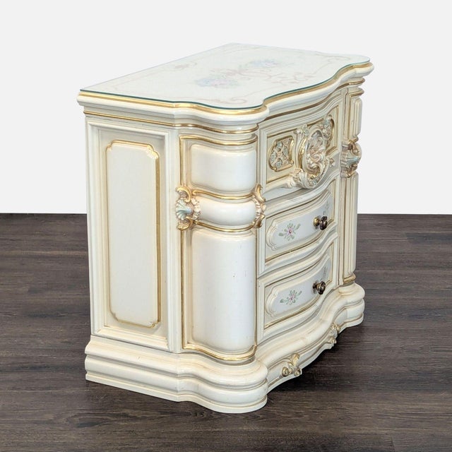Heavily carved with gold accents and glass protective top. Dimensions (in): 26W x 15D x 25H.