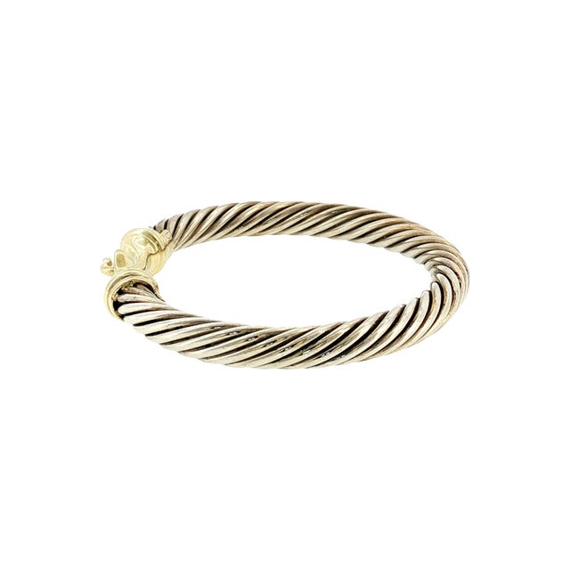 A late 20th-century sterling silver and 14k gold David Yurman bangle bracelet. This is a striking piece. The bracelet...