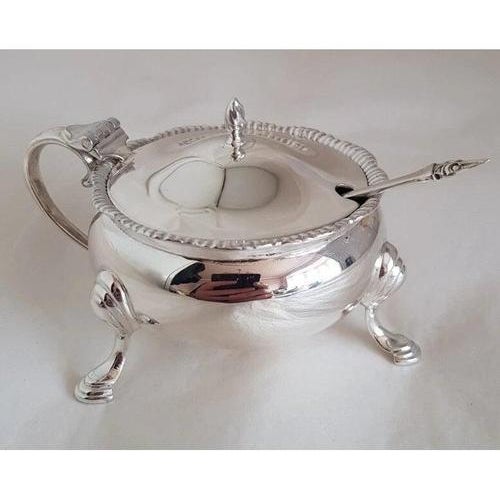 A refined vintage English sterling silver mustard pot and accompanying spoon by the celebrated silversmiths Edward Barnard...