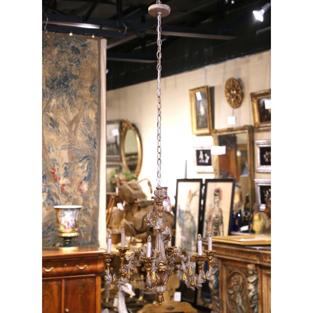 Richly sculptural and highly decorative, this vintage chandelier captures the exuberant spirit of Italian Rococo design...