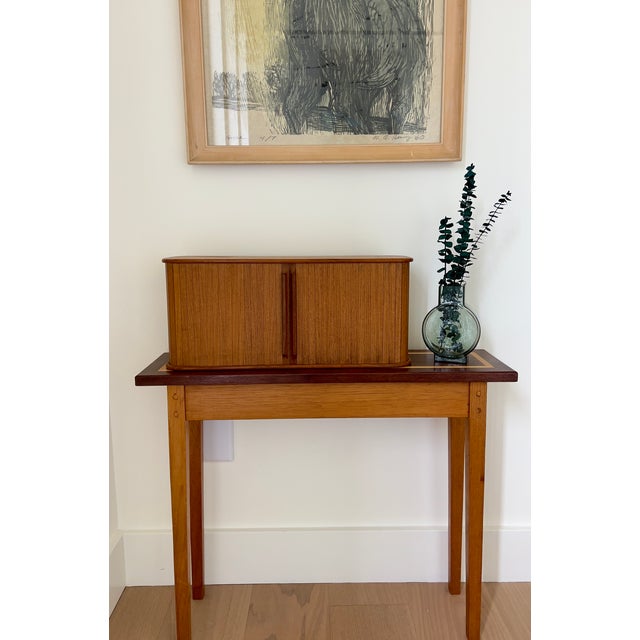 A mid-century masterpiece in miniature. This teak storage chest mimics the iconic aesthetic of full-scale Scandinavian...