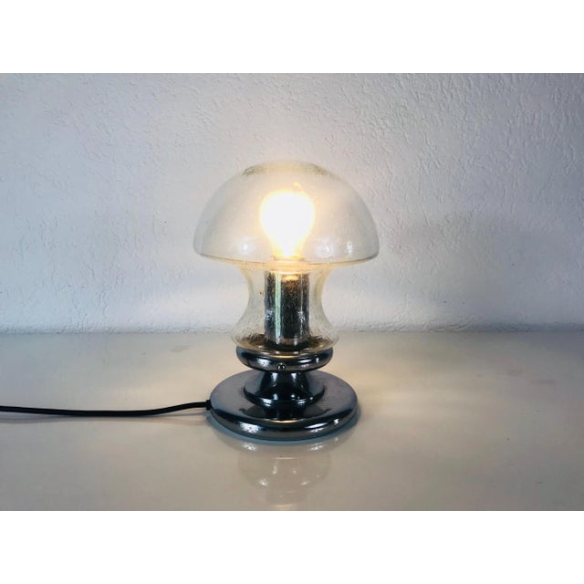 A Doria table lamp made in Germany in the 1970s. It is fascinating with its rare glass shape. The design of the lamps is...
