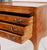 A charming French Provincial style side chest featuring three drawers, a pull-out slide, and an elegant silhouette raised...