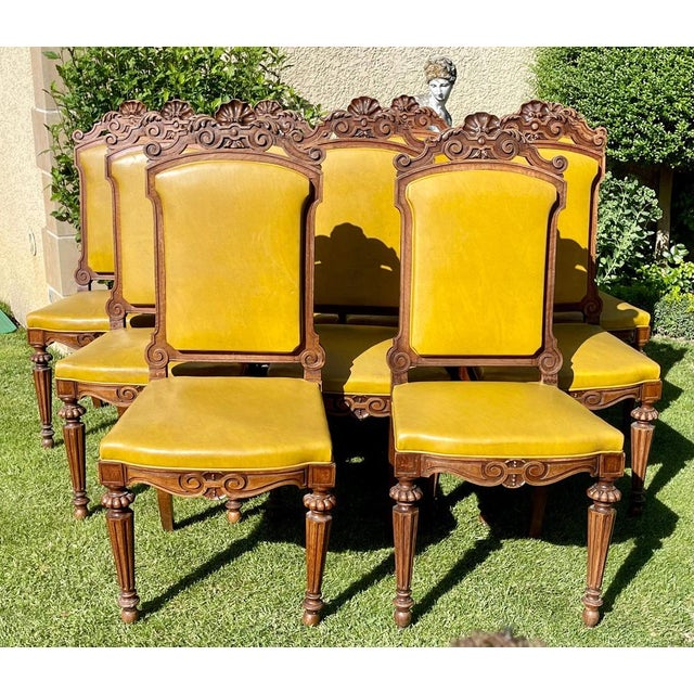 Suit of 9 carved walnut chairs Napoleon III period - XIXth. They are covered with mustard yellow imitation leather. The...