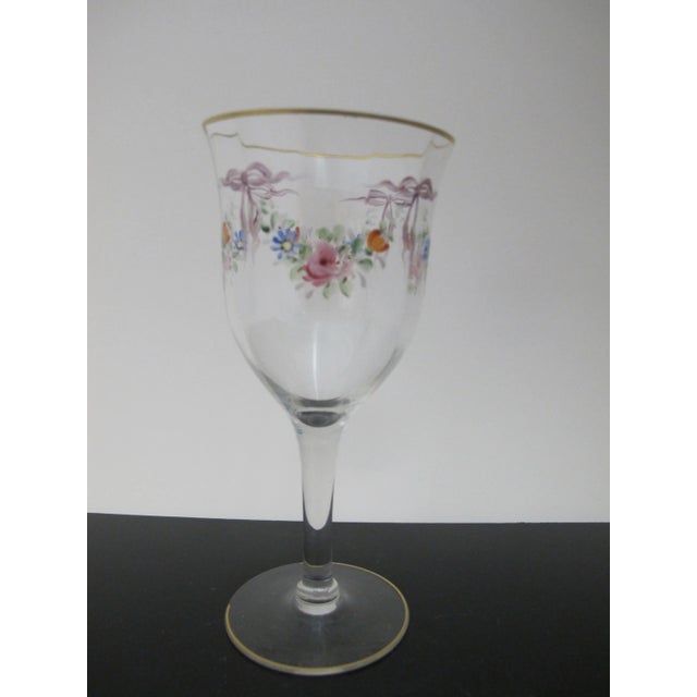 Very sweet vintage wine glass. Clear glass with hand painted colorful floral and bow design. Rim has gold gilt accent....
