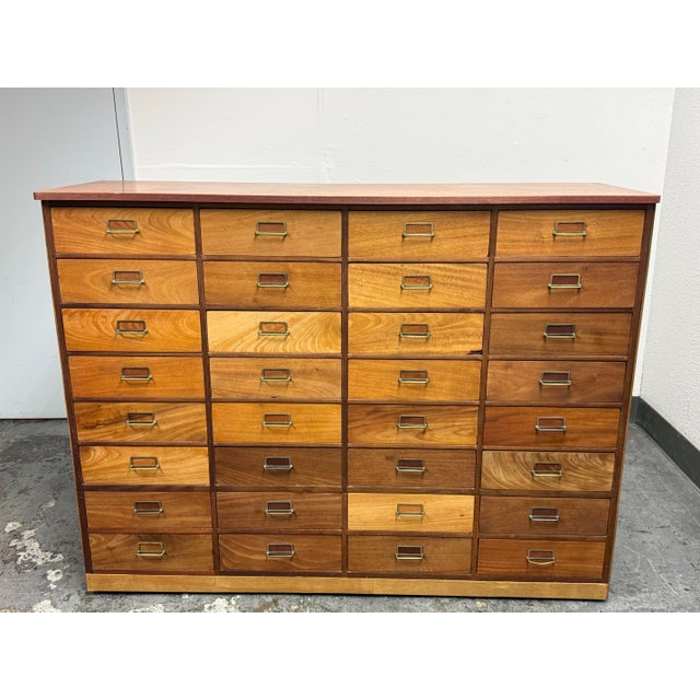Design Plus Gallery presents an Apothecary Cabinet with Thirty-Two Drawers. These drawers are arranged in four columns of...