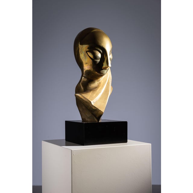 This brass sculpture embodies the Futurist-Cubist style with a distinctly modernist edge. The elongated head, stylized...