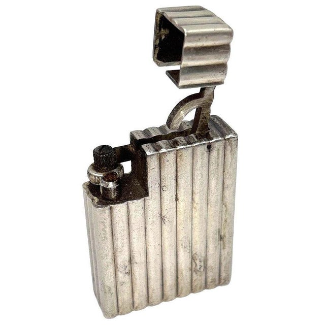 1930s Art Deco Solid Sterling Silver Lighter by Cartier with a serial number of S11315, the petrol lighter features...