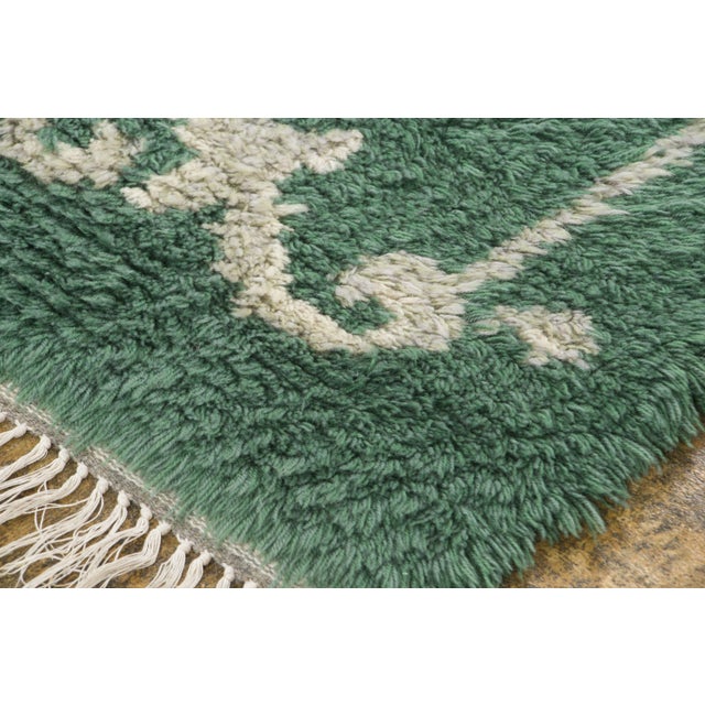 Hand-knotted in wool and originating circa 1950-1959 from Sweden, this 4x6 vintage Swedish rya rug joins Rug & Kilim’s...