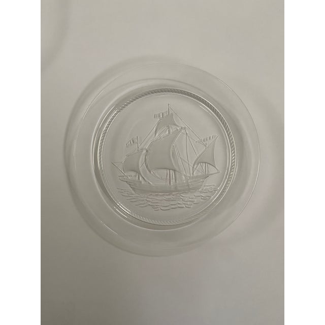 Elegant set of two signed Lalique frosted glass plates featuring beautifully detailed sailing ship designs in relief....