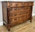 An elegant Antique French walnut chest of drawers featuring a striking marble top, beautifully carved drawer fronts and...