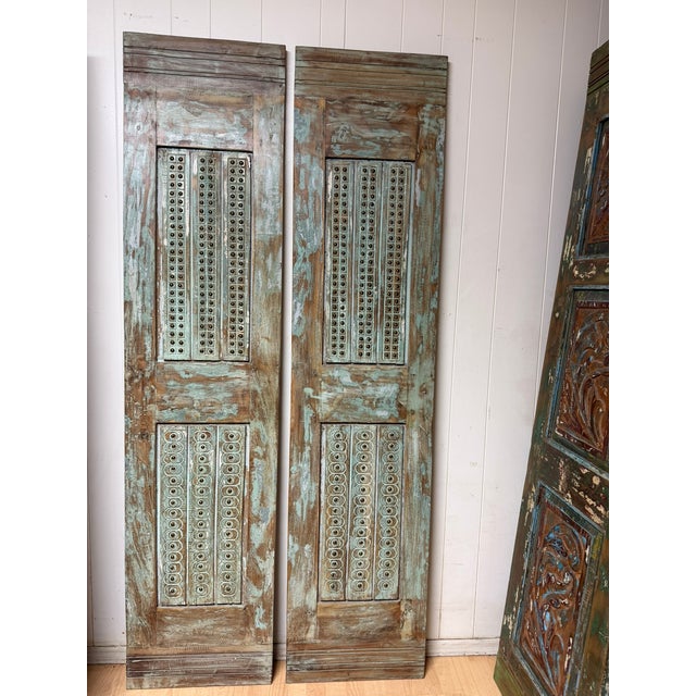 Bring timeless character and old-world craftsmanship into your home with these antique Indian carved wood doors featuring...