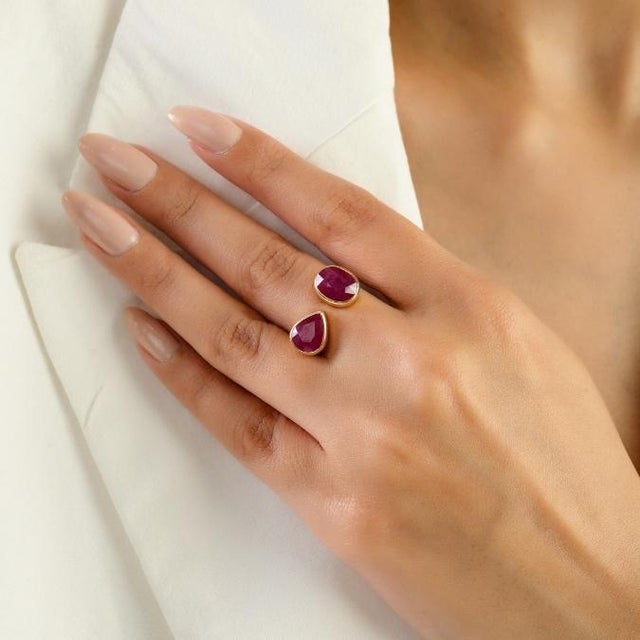This elegant Toi et Moi ring features 2 natural oval and pear cut rubies totaling 4.6 carats set in rich 14k yellow gold....