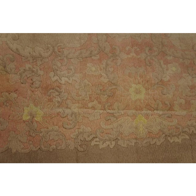 Definitely a soft pink tone-on-tone carpet with a complex and dense border of leaves and flowers. Very much a boudoir...