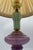 Classic-style table lamp with a truncated cone-shaped lampshade in ivory-colored pleated fabric, embellished with...