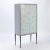 A stylish custom-made cerused oak cabinet having mosaic glass doors and resting on a painted black steel frame in the...